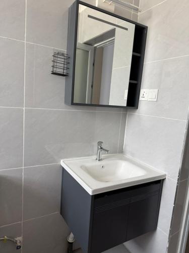 a bathroom with a sink and a mirror at Nessie Homes in Nairobi