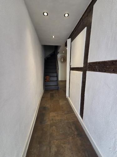 an empty hallway with a staircase in a house at Der kleine Eifel-Ritter in Manderscheid