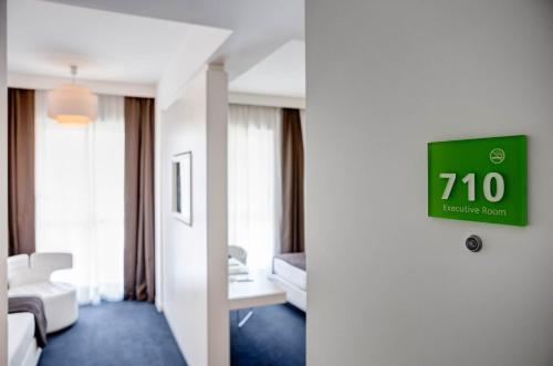 a hotel room with a clock on the wall at iH Hotels Roma Z3 in Rome