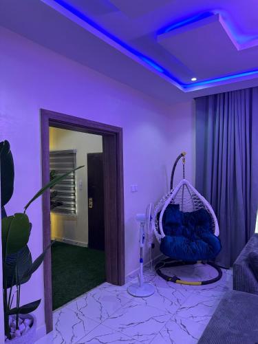 a purple room with a mirror and a swing at Floesth Ville in Mama