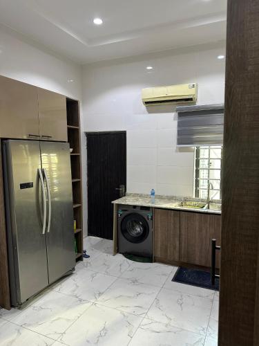 a kitchen with a stainless steel refrigerator and a dishwasher at Floesth Ville in Mama