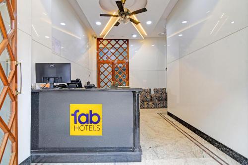 a reception desk in a lobby with aedia hotels sign at FabHotel Wellesley in Kolkata
