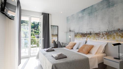 a bedroom with a bed and a large window at VILLA MON AMOUR by Villas Guide in Blato