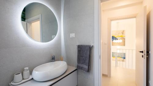 a bathroom with a white sink and a mirror at VILLA MON AMOUR by Villas Guide in Blato