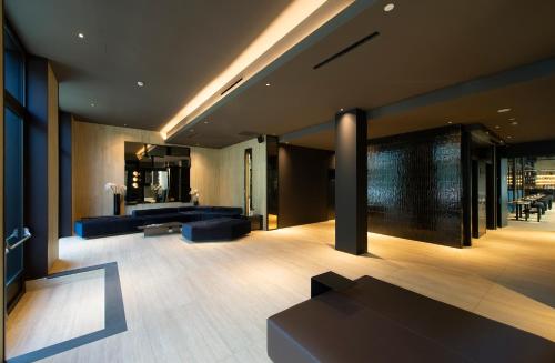 a living room with couches and tables in a building at Palazzo Loreto Hotel Milano in Milan