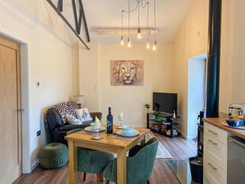 a living room with a table and a couch at Serenity- Uk38551 in Endon