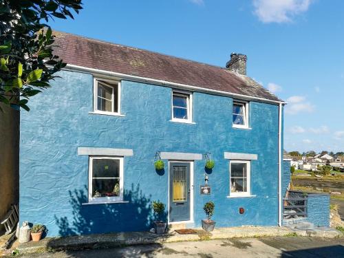 a blue house with white windows at Oystercatcher Cottage in Haverfordwest