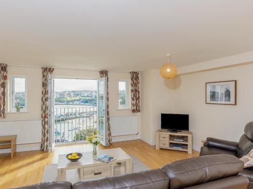 a living room with a couch and a television at 6 Harbour View in Newquay