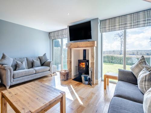 a living room with a fireplace and a tv at Speed The Plough- Uk43631 in Grange