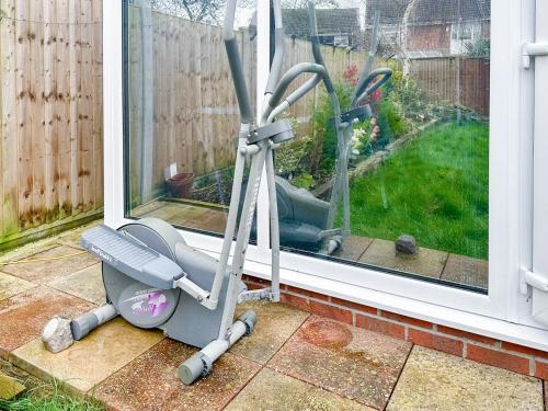 a exercise machine sitting in front of a window at Sunrise Villa in Clacton-on-Sea