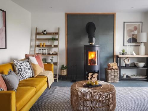 a living room with a couch and a fire place at Acacia in West Worlington