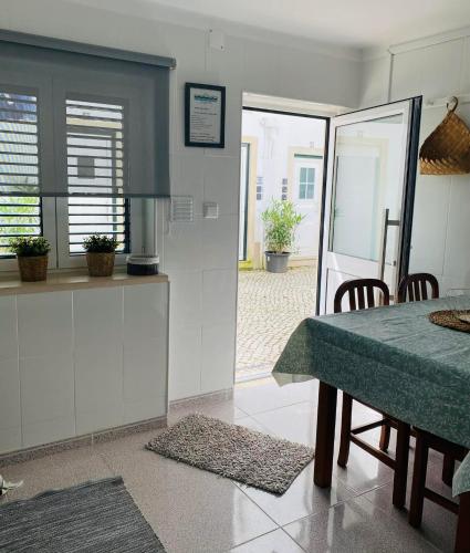 a kitchen and dining room with a table and chairs at Casa BeijoMar in Nazaré