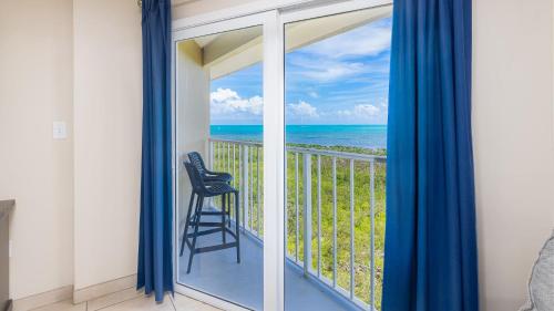a balcony with a view of the ocean at Coastal Joy 3412 Ocean Pointe in Tavernier