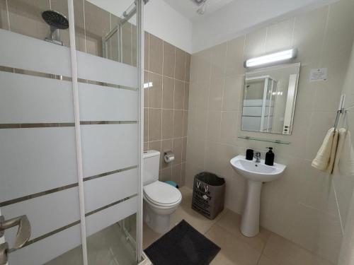 a bathroom with a toilet and a sink at Elysia Park Star in Paphos