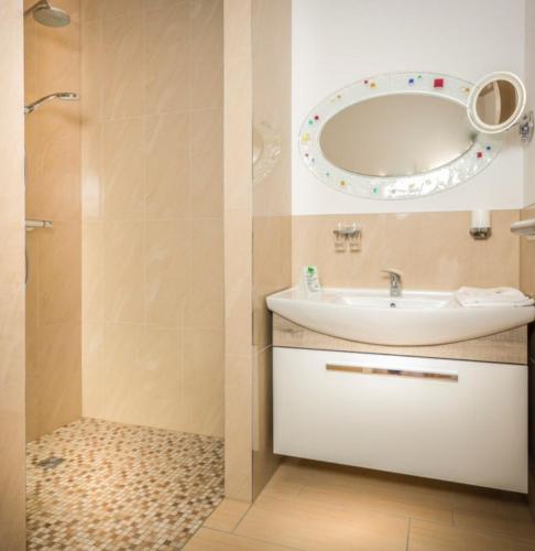 a bathroom with a sink and a mirror at Central Suites in Greifswald