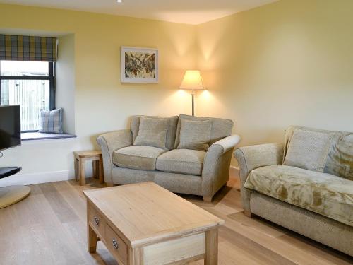 a living room with two couches and a coffee table at The Haymakers in Grange