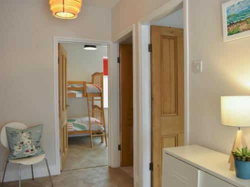 a hallway with a door leading to a bedroom at Hyem in Amble