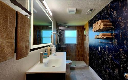 a bathroom with two sinks and a toilet at Ambervine in Lowell