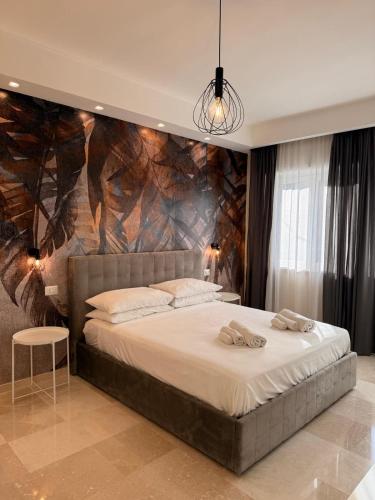 a bedroom with a large bed with a stone wall at Suite 55 in Trani
