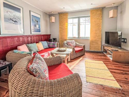 a living room with two couches and a television at Holiday Home Kapitänshaus Leo by Interhome in Leopoldshagen