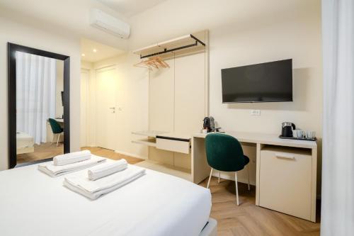 a bedroom with a bed and a desk and a television at Italianflat - Duomo Atmosphere Two in Milan
