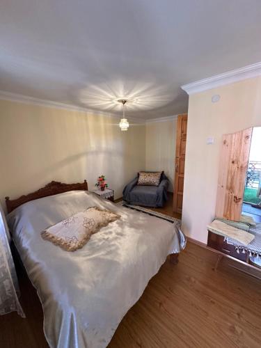 a bedroom with a large bed and a window at Guest House Iura in Sighnaghi