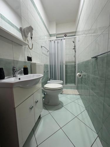 a bathroom with a toilet and a sink and a shower at B&B Da Simone in Battipaglia