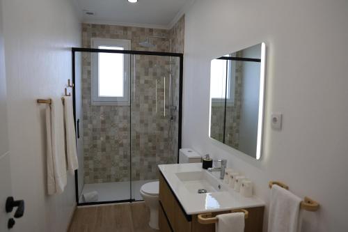 a bathroom with a sink and a shower at Olivale Villas in Campo Maior