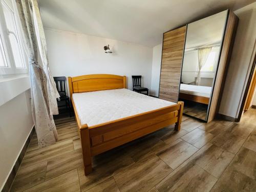 a bedroom with a bed and a mirror at Bird House in Krimovice
