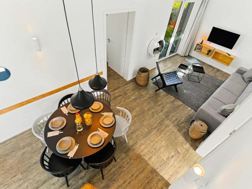 a living room with a table and a couch at Holiday Home Haus Schmidt - 305 by Interhome in Lembruch