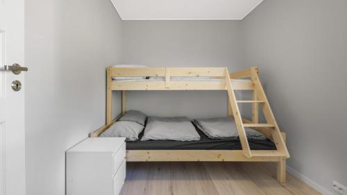 a bunk bed in a room with a ladder at Kvitefjell 35 in Loen