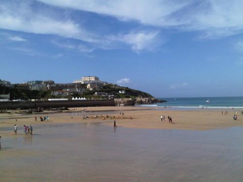 a group of people standing on a beach at 1 Harbour View in Newquay