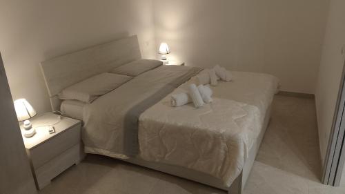 a bedroom with a large bed with towels on it at Thysia in Conversano