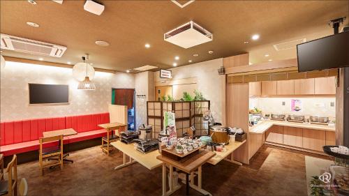 a restaurant with a table and chairs and a counter at Daiwa Roynet Hotel Hachinohe in Hachinohe