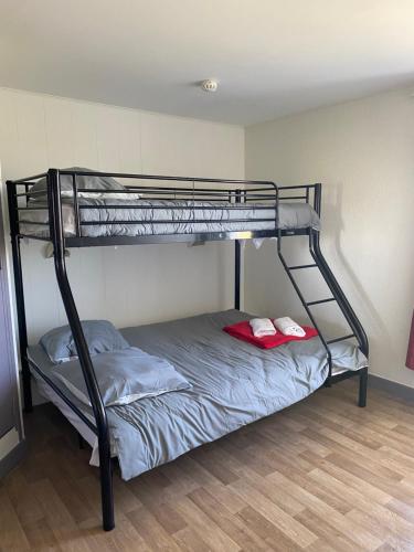 a bunk bed with two red pillows on the bottom bunk at Fast hôtel Troyes in Barberey-Saint-Sulpice