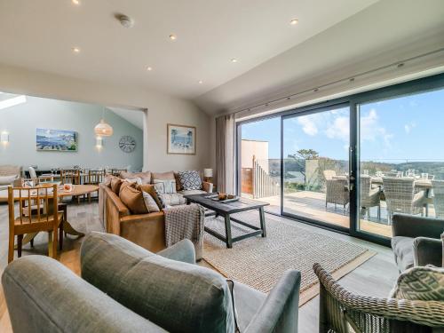 a living room filled with furniture and a large window at Long Commons in Saint Mawes