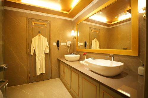 a bathroom with two sinks and a large mirror at Clarks Khajuraho in Khajurāho