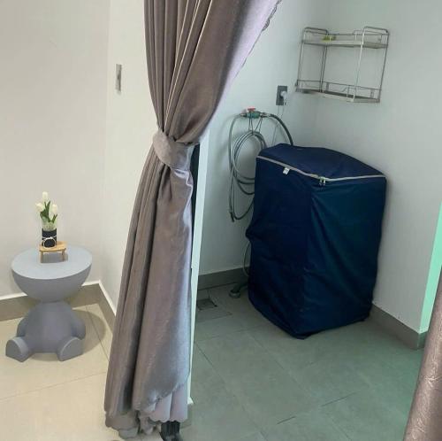 a bathroom with a shower curtain and a toilet at SOHA House in Rạch Giá