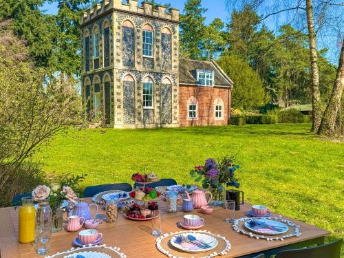 a table with food on it in front of a building at Falconer's Lodge in Didlington