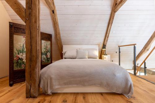 a bedroom with a bed in a room with wooden beams at Gut Junkernhof in Calden