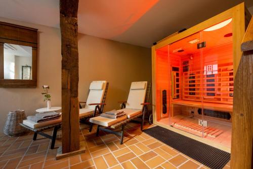 a room with two chairs and a glass wall at Gut Junkernhof in Calden