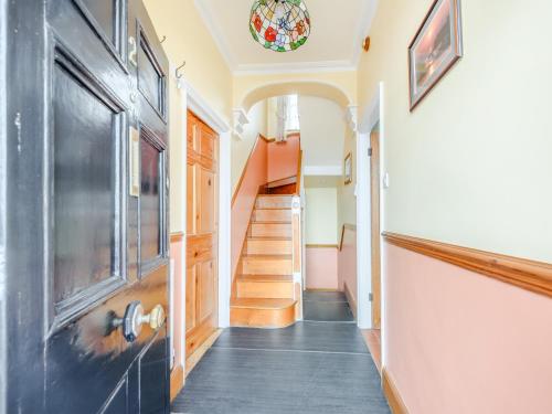 a hallway with a staircase and a stair case at Awel-Y-Mor in Aberaeron