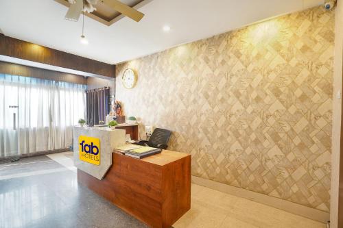 an office with a reception desk and a wall with a wall at FabHotel Garden Tree in Bhubaneshwar