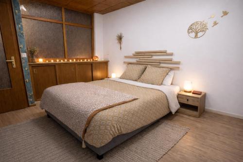 a bedroom with a bed and a window and books at L'Atelier des Rêves in Saverne