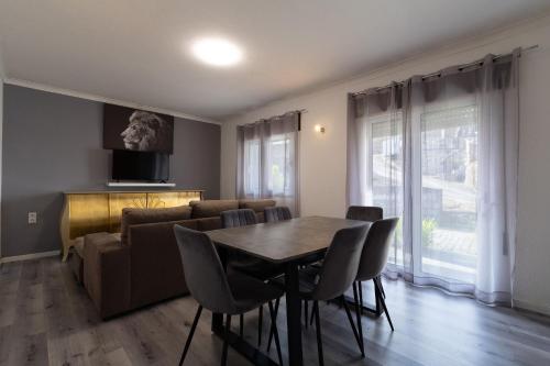 a living room with a table and a couch at Gerês Home Nature in Geres