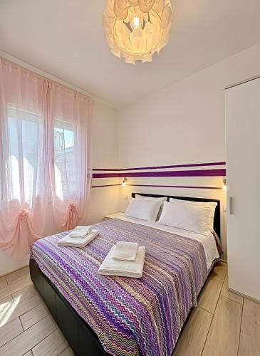 a bedroom with a bed with two towels on it at The Sea Pearl Suite in Punta Marina