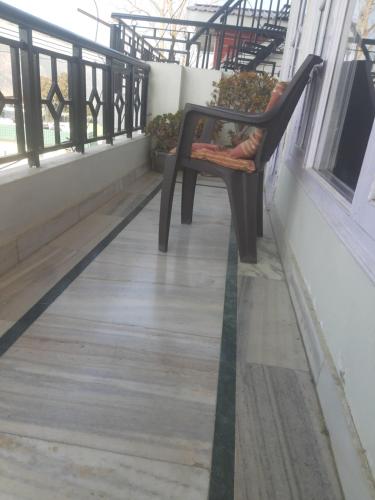 a bench sitting on the balcony of a building at Ghar Family-Homestay- 2 Room -Prime Location - Balcony kitchen-Don't book Single Room Book a complete Home in Solan