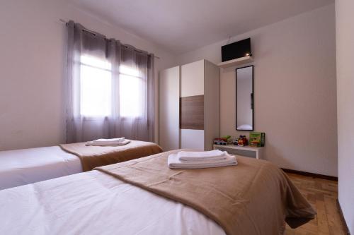 a room with two beds and a mirror and a window at Gerês Home Nature in Geres