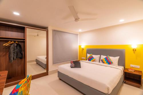 a bedroom with a large bed and a mirror at goSTOPS Plus Katra in Katra