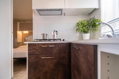 a kitchen with a sink and a counter top at Club del Sole La Risacca Family Collection in Porto SantʼElpidio